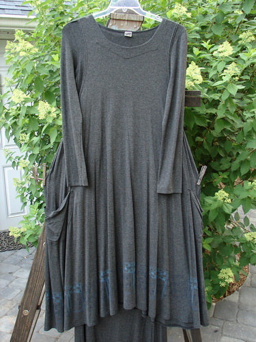 2000 Rayon Lycra Midi Bubble Trio Sparkle Border Charcoal Size 1 2: A dress on a rack, featuring a long grey dress on a swinger, with a unique fall and sway, dippy size pockets, and a gentle scooped neckline.