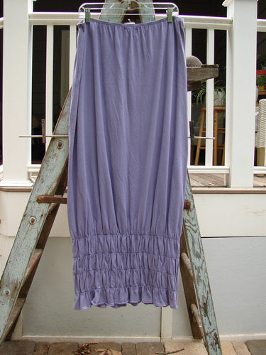 2000 NWT Rings of Saturn Skirt Unpainted Twilight Size 2: A light purple skirt with smocking detail on a ladder.