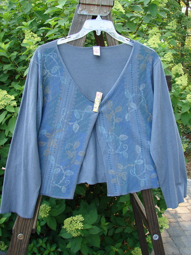 A blue cotton lycra long-sleeved shrug with a trailing garden vine theme paint. Open front, regular width sleeve, and varying hemline. Size 1.