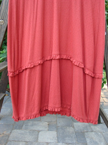 2000 Wool Pointelle Lulu Slip Dress Sienna Unpainted Tiny Size 2: A red dress with eyelets, thin straps, and a criss-cross bodice on a wood chair.