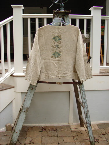1999 Summercloth Hemp Crop Jacket Nature Cement Size 1: A white shirt with a nature-inspired design on it, featuring a boxy and vented crop length, metal button front, drop shoulders, and double front drop billowy pockets.