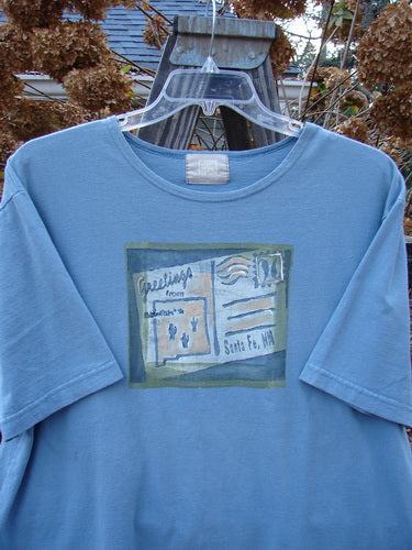 2000 Short Sleeved Tee Greetings from Santa Fe Blue Jet Size 1: A blue t-shirt with a postcard theme paint and a Blue Fish patch.