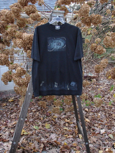 2000 Short Sleeved Tee Austin Texas Black Size 1: A black shirt with a picture on it, featuring a thicker ribbed neckline and a fairly straight shape. Classic Austin Texas theme paint and the best signature Blue Fish patch.