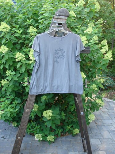 Barclay Batiste Cap Sleeved Top Night Bird Storm Grey Size 1: A t-shirt on a rack with a slight A-line flair and sweet cap sleeves.