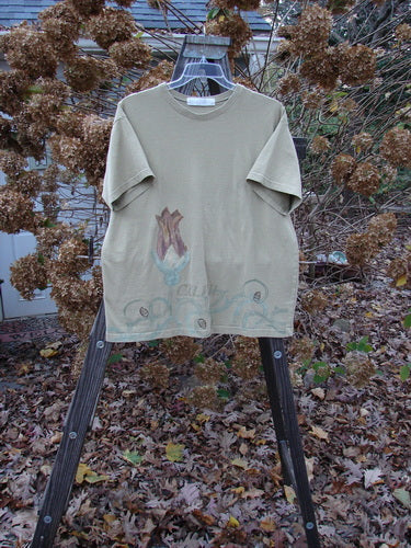 Image: A t-shirt with a picture of colorful botanicals and a floral bud theme painted on it, displayed on a rack.

Description: 1998 Botanicals Short Sleeved Tee CXLVIII Seed Size 1. This tee is from the Spring Botanicals Collection, made of medium weight organic cotton jersey. Features include a thicker ribbed neckline, a fairly straight shape, and the signature Blue Fish patch. Bust 50, Waist 50, Hips 50, Length 30 inches.