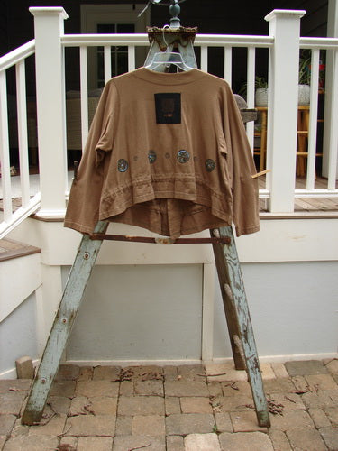 1997 Treehouse Jacket Tiny Pinwheel Portico Size 1: A brown jacket on a ladder with a patch on it. Versatile and fun, featuring a double paneled V neck, drawcord flounce, and Blue Fish buttons.