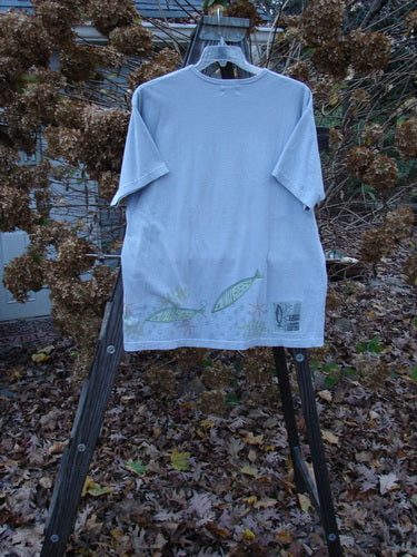 1999 Short Sleeved Tee Fish Triple Water Size 1: A t-shirt with fish drawings on it, featuring a thinner ribbed neckline and a straighter shape. The tee is made from medium weight organic cotton jersey and includes a Blue Fish patch.