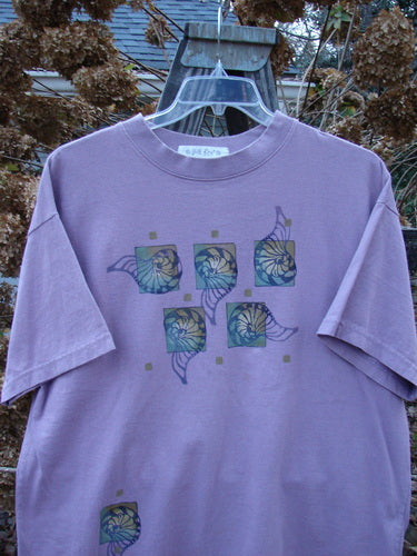 1997 Short Sleeved Tee Five Shell Jasmine Size 1: A purple shirt with a design on it, featuring a thicker ribbed neckline and a slightly shorter, boxier shape. Made from medium weight organic cotton jersey.