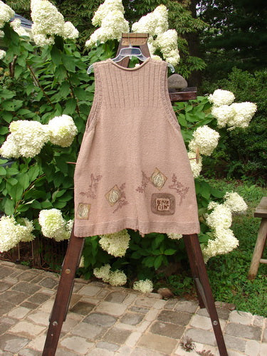 1998 Teton Sweater Vest Tiny Twig Aspen OSFA: A dress on a swinger, a brown dress on a wooden stand, a towel on a ladder, and a close-up of a dress.