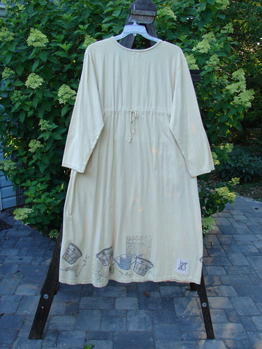 Image alt text: 1999 Tea Time Dress with Fancy Pot Paint, Size 2, on a swinger with hourglass shape, wider hip, and hemline. Feminine and detailed design.