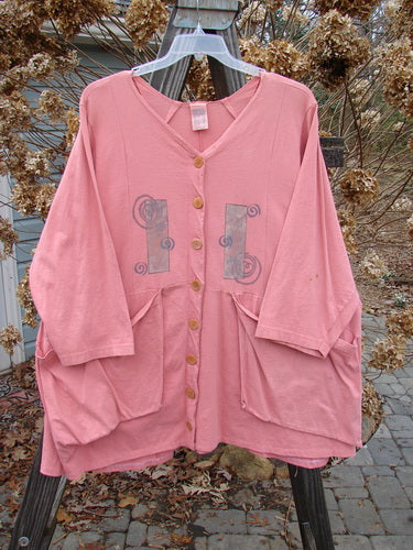 1994 Treasure Jacket Wind Spin Altered Coral OSFA: A pink jacket with a design on it, featuring drop shoulder seams, front flop pockets, and a V-shaped neckline.