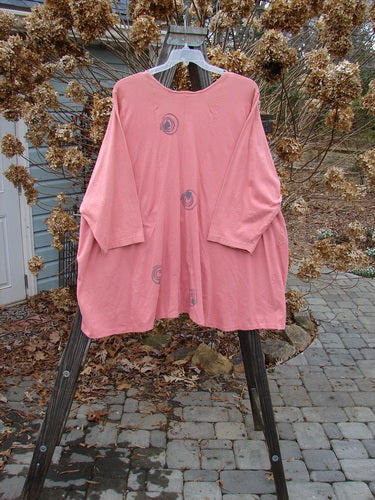 1994 Treasure Jacket Wind Spin Altered Coral OSFA: Pink shirt on a rack with holes, drop shoulder seams, and front flop pockets.