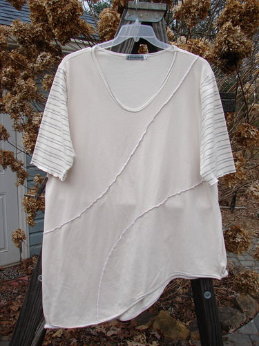 A slenderizing white shirt with raised seams, a U-shaped neckline, and lettuce edges. Made from organic cotton and lycra, this Barclay Slant Stripe Form Top in Natural is a collectible piece from the Summer Collection. Size 2.