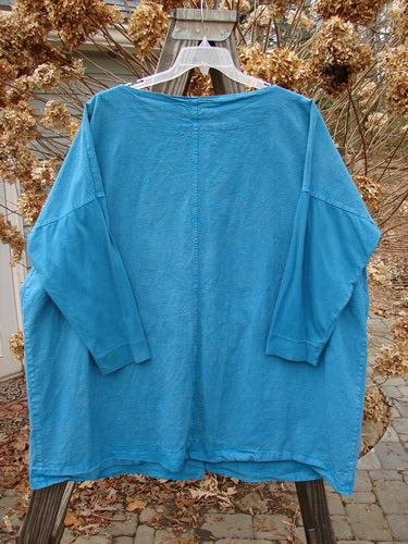 Aqua Barclay Cotton Sleeve Hemp Jacket, Size 2. Full metal button front, boatneck, oversized painted pockets. Slimmer organic cotton sleeves, sectional vertical panels. Unpainted with a slightly shallow shaped neckline. Bust 62, waist 62, hips 62. Length 33 inches.