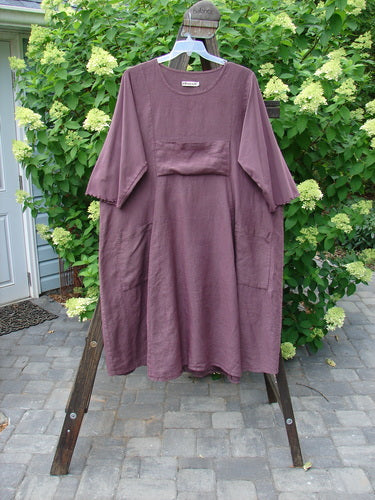 Barclay Linen Cotton Sleeve Upper Pocket Dress Unpainted Red Plum Size 2: A dress with sectional panels, a rounded neckline, and three-quarter length sleeves with lettuce edge. Features a horizontal upper bodice pocket and a drawcord back. Length is 45 inches.