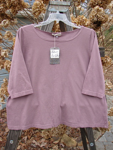 A New With Tag Center Seam Playful Crop Top in Rosewood, made from Mid Weight Organic Cotton. Features include Three Quarter Length Sleeves, a Wider Boatneck Flattened Neckline, and a Sweet A line Shape with a Center Vertical Seam. Size 2.