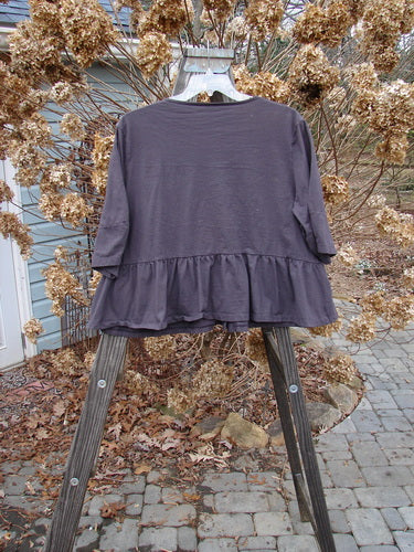 Image alt text: "Barclay Peplum Pocket Jacket in Brum, size 2, featuring a purple shirt on a swinger and a close-up of a shirt on a rack. Outdoor clothing with a pattern (fashion design), perfect for autumn. Made from organic cotton. Vintage Blue Fish Clothing by Jennifer Barclay."