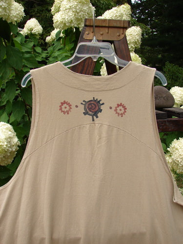 1996 State Fair Vest with giant abstract design on tan shirt. Swinger wearing vest with cloth-covered button, double paneled hemline, and wide A-line shape.