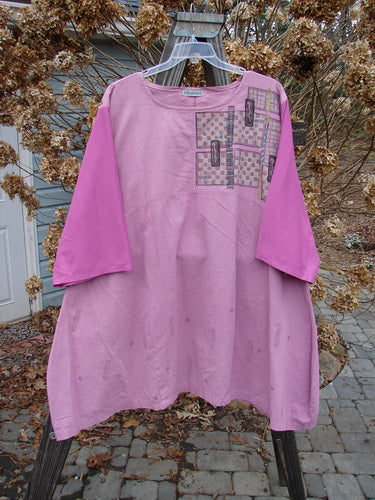 A pink shirt with a pattern on it, part of the Barclay Cotton Sleeve Hemp Linen Sectional Dress Cobblestone Rose Size 2.