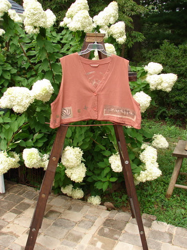 1994 Spruance Vest with medallion rose design on a clothes rack