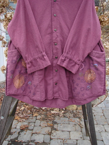 2000 Flannel Poet's Top Spin City Murple Size 2: A purple jacket on a rack, featuring a uniquely styled jester's collar, rounded vented hemline, and mix-matched pull cord lower sleeves. Two oversized angled front pockets and tons of tiny original buttons complete the design.