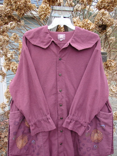 2000 Flannel Poet's Top Spin City Murple Size 2: A purple shirt with a floral design, jester's collar, vented hemline, and pull cord lower sleeves. Features oversized angled front pockets and original buttons.