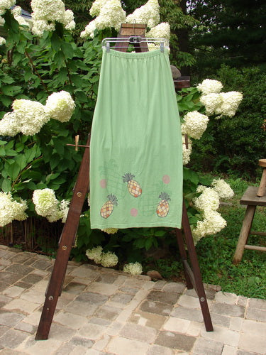 1999 Straight Skirt Pineapple Spearmint Size 0: A green skirt with a slight A-line flare and pineapple theme paint around the hemline. Features a full elastic waistline and the signature Blue Fish Patch. Made from mid-weight organic cotton. Length is 38 inches.
