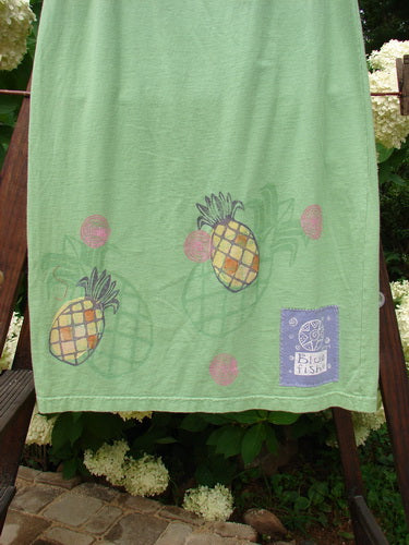 Image alt text: "1999 Straight Skirt Pineapple Spearmint Size 0: A towel with green pineapples on it, part of the Summer Collection. Full elastic waistline, A-line flare, and Blue Fish Patch. Mid-weight organic cotton, 38 inches long."