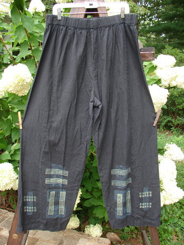 2000 Waveline Pant Grid Block Black Size 2: A pair of pants on a clothesline. Light weight hemp with a unique flat button front waistline and generous hip measurement. Slight crop length with supreme big block grid theme paint and a nice drape. Waist: 34-48, Hips: 48, Inseam: 25, Length: 40.