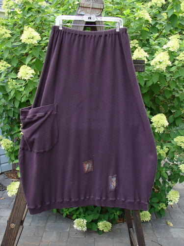 Barclay Patched Thermal Side Pocket Skirt Dream Red Plum Size 2: A cotton thermal rib skirt with a ribbed hemline, vertical panels, and an oversized bottom side pocket. Wide shape, superior patches, and elastic waistline. Length: 40".