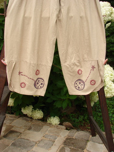 1996 Boulevard Pant Star Travel Dune Size 1: Organic cotton trouser with drawings. Elastic waist, side pockets, painted cuffs with buttons. Shorter rise. Measurements: Waist 26-40, Hips 50, Inseam 23, Length 38.