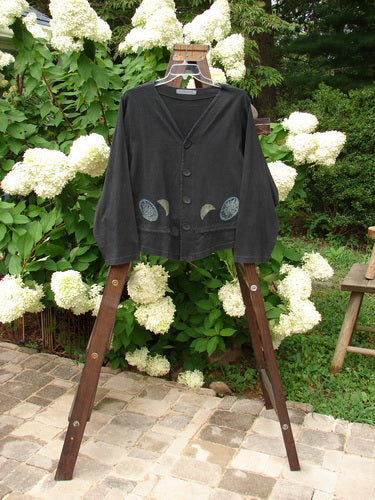 1997 Treehouse Jacket Many Moons Cast Iron Size 2: A black jacket on a swinger with a moon design on it.