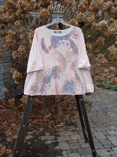 A Barclay Three Quarter Sleeved Textured A Lined Tee Top Cloud Burst Natural Size 2. A white shirt with a painted design on it, featuring a significant continuous cloud burst theme.