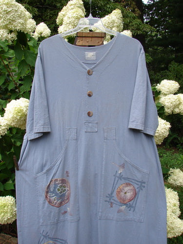 Image: A blue shirt with buttons and a design on it.

Alt text: 1999 Sukura Dress Asian Fan Bluestone Size 2: A blue shirt with buttons, an optional accent belt, and elongated off-set pockets.