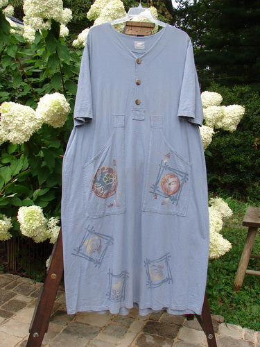 1999 Sukura Dress Asian Fan Bluestone Size 2: A dress on a rack with a blue shirt featuring a design. Person's legs in a blue dress. Close-up of a white flower.