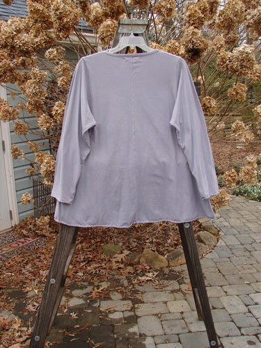 A lavender Barclay Long Sleeved A Lined Tee Top with cozy sleeves and curled edgings, swinging on a swinger.