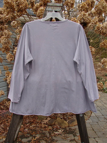 Image alt text: Barclay Long Sleeved A Lined Tee Top on a swinger, featuring cozy sleeves, sweet curled edgings, and arrow side theme paint.