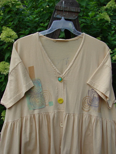 1995 Tree Top Dress with floral buttons on a beige shirt