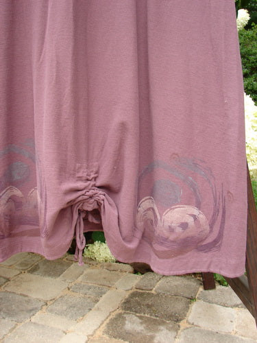 2000 Crepe Tara Dress Celtic Loam Size 1: Close-up of elegant pink curtain fabric with delicate loop closures, pewter buttons, and flowing drape.