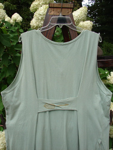 1995 Arbor Vest Kitchen Mixer Dinette Green OSFA: A green shirt on a swinger, featuring a deep V-shaped neckline, rounded front and back shirttail hemline, and tall rounded vented sides. It has a front painted breast pocket, a sweet tabbed upper rear, and super back drop gathers. Made from organic cotton, this vintage Blue Fish Clothing piece is from the Spring Collection of 1995 and is in perfect condition.