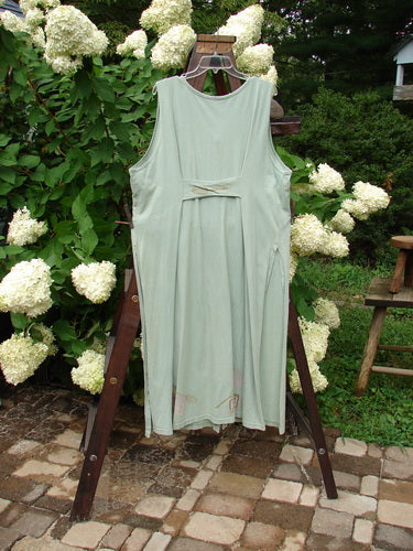 Image alt text: "1995 Arbor Vest Kitchen Mixer Dinette Green OSFA: A dress on a rack with a wooden bench and a white shirt. Floral design and plant accents."