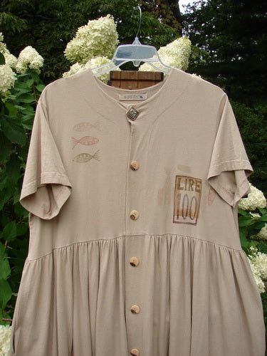 1998 Messenger Dress Lire Quill Size 1: A shirt with fish and numbers on it, featuring an empire waist seam, deep pockets, and original blue fish buttons.