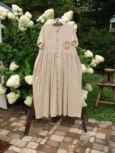 1998 Messenger Dress Lire Quill Size 1: A dress on a rack, featuring a wide gathered waist seam, empire seam, and deep size pockets.