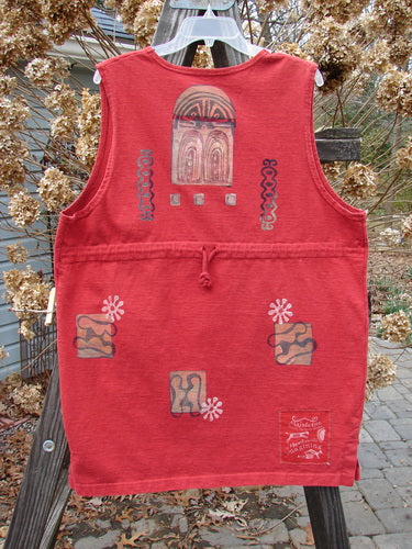 A vintage Symbol Vest from the 1996 Holiday Collection in Pomegranate. Made of heavy weight organic cotton with a shallow neckline, oversized button, and knotted textured buttons. Features tiny vented sides, a straighter shape, and a Blue Fish Patch. Size 1.