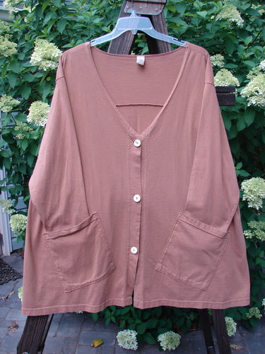 A Barclay Triangle Cardigan in Dusty Ochre, Size 2. Features include a deep V neckline, widening lower hem, funky front pockets, and original buttons. Unpainted for easy coordination with other pieces. Made from medium-weight organic cotton.