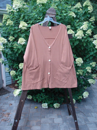 Barclay Triangle Cardigan Unpainted Dusty Ochre Size 2: A brown shirt with buttons on a swinger, featuring a deep V neckline, widening lower hem, and funky front pockets.