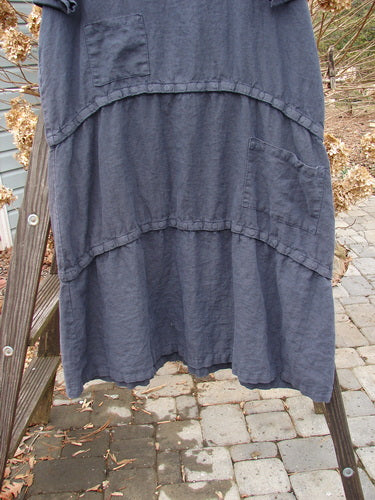 Barclay Linen Three Length Snap Dress Unpainted Blue Raven Size 1: A versatile blue dress with a rounded neckline, straight shape, and snap lengths. Features two front pockets and continuous horizontal snap tape.