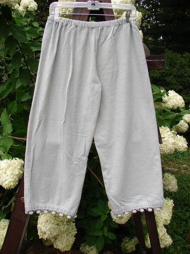 1999 PJ Pant Pom Pom Unpainted Solstice Blue Size 0: A pair of pants with pom poms on the cuffs, made from heavy weight flannel. Crop length, draw cord front waistline, elastic backing, and no pockets.