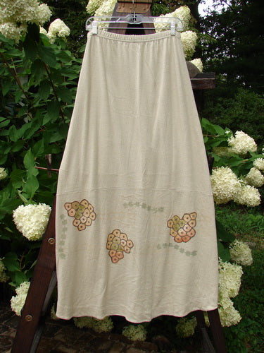 2000 Cotton Hemp Shade Skirt Bio Dove Size 1: A skirt on a clothesline, featuring a white flower in a heart shape.