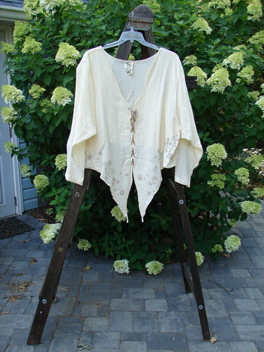 1997 Gauze Pickle Jacket Garden Path Kauiclla Size 2: A white shirt on a clothes rack, with hand-dyed silk ribbon closures.